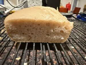 Short/flat bread-machine sourdough loaf.